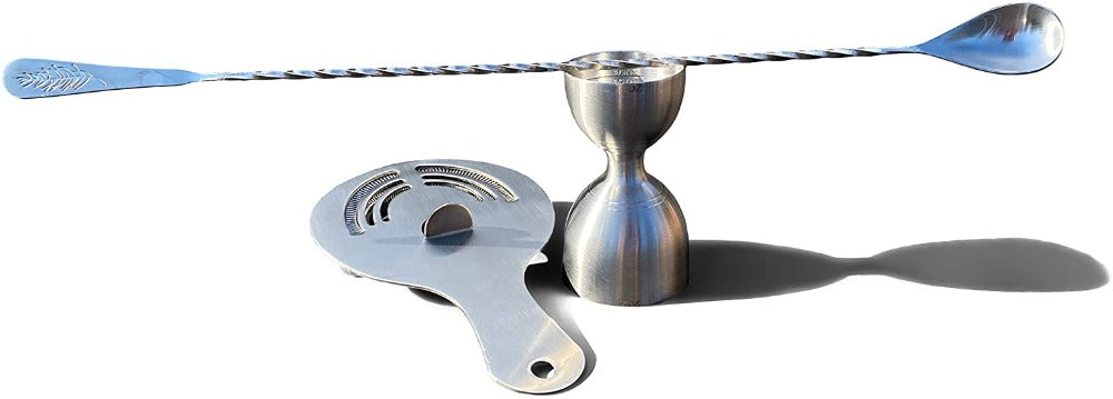 Amehla's Three piece cocktail essentials kit for bartenders and mixologists. Kit includes stainless steel rounded double jigger, hawthorne strainer, and bar spoon.