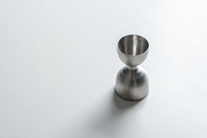 Stainless steel rounded double jigger from Amehla's three piece bartender kit.